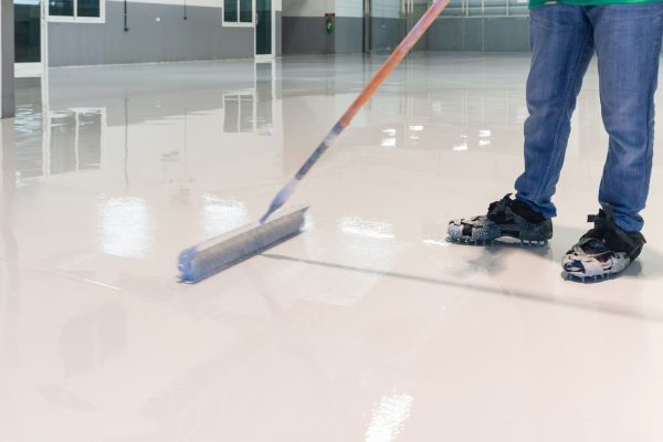 Construction series: Worker working on epoxy floor